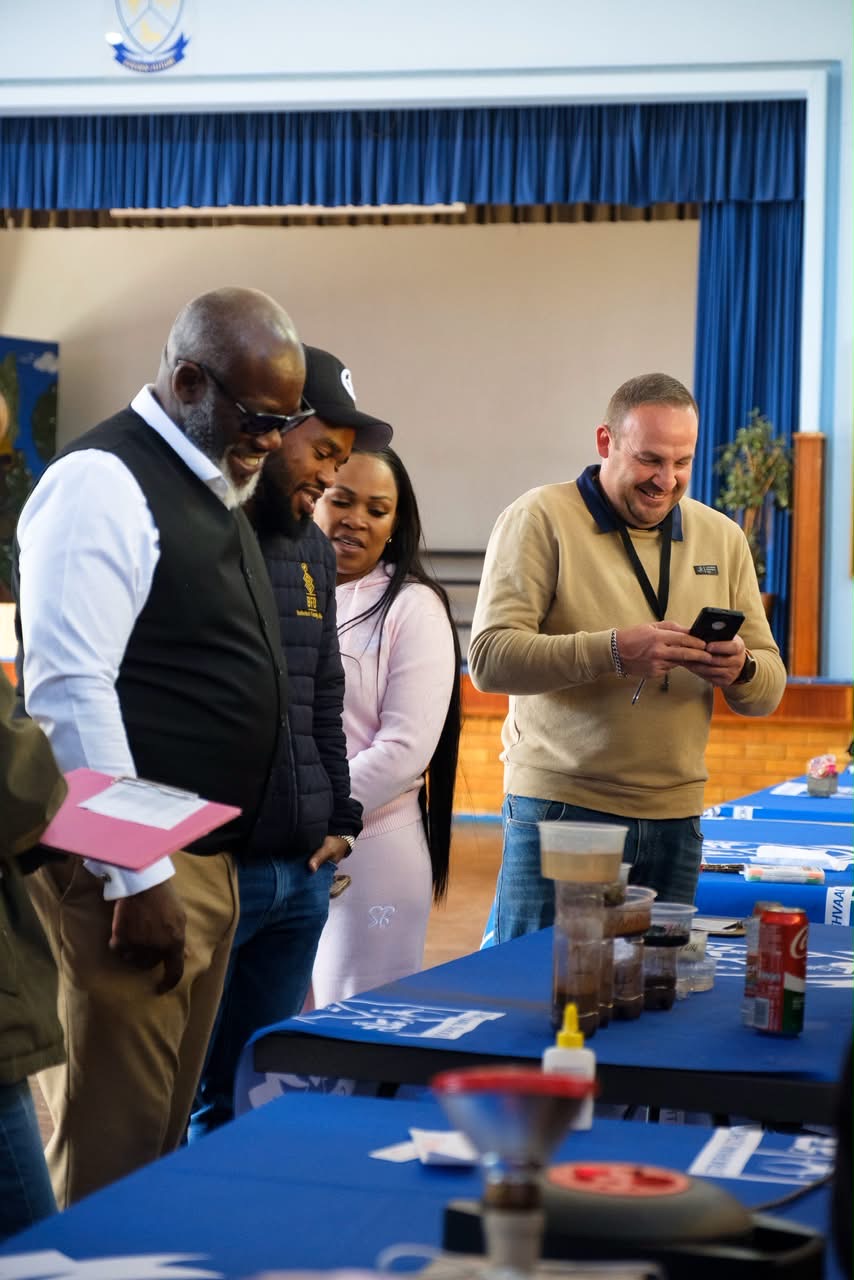 Buthelezi Family Office team sharing a light moment with parents at the Strathvaal outreach day